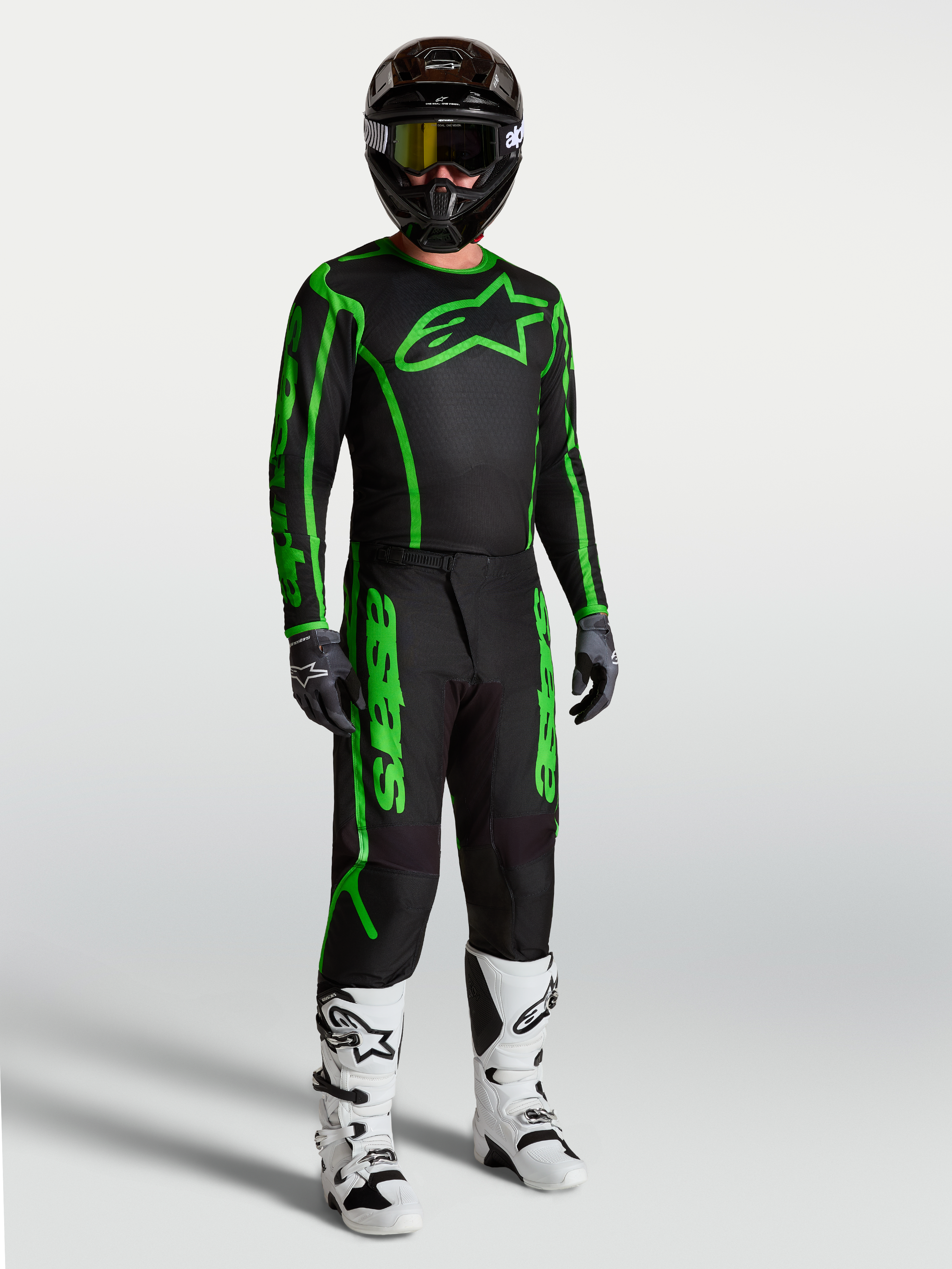 Alpinestars Fluid Apex V2 Pants, Men's Motocross Racing Gear, Black and Green Fluo, durable polyfabric with ergonomic fit, shown as a full gear set with white boots.