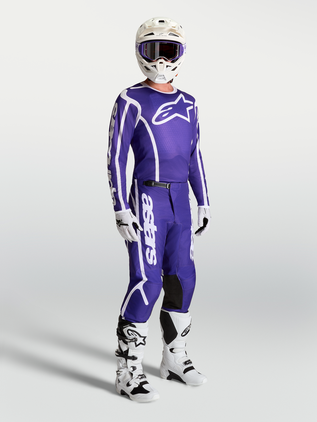 Alpinestars Fluid Apex V2 Jersey and matching pants, Deep Blue and White motocross gear set on-model with white boots and helmet.