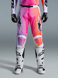Alpinestars 2026 Racer Air Portl Pants, Motocross Pants, vibrant purple pink and orange gradient, featuring bold star logos on the thighs, worn with white racing boots and black gloves, designed for high-performance off-road riding.