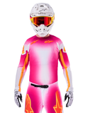 Motocross rider wearing the Alpinestars Limited Edition Supertech AFD MIG Jersey, Pink Fluo White gradient design with orange star logos, matching pants, white helmet, and red-tinted goggles, elite off-road racing apparel.