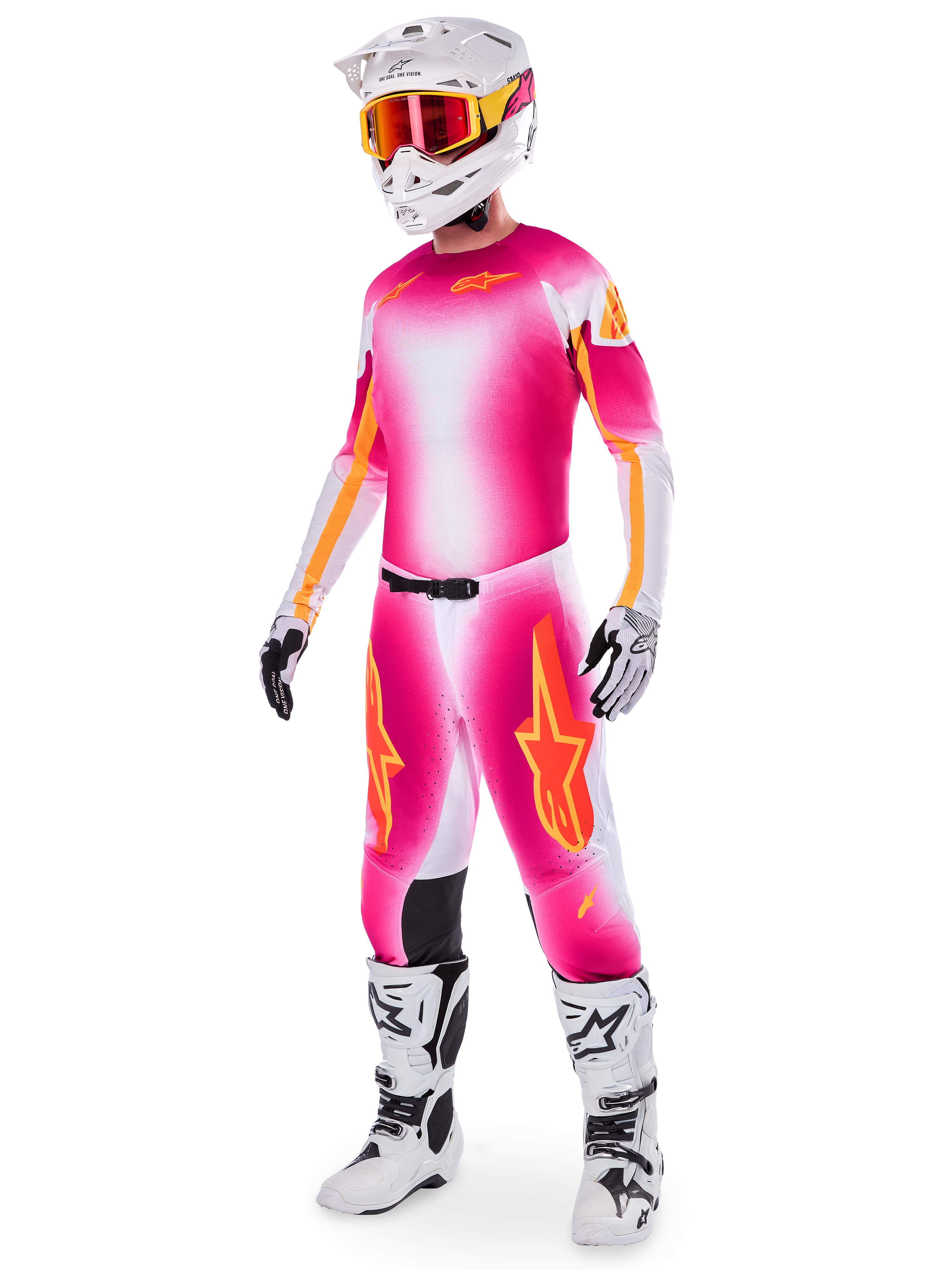 Motocross rider wearing the Limited Edition Supertech AFD MIG Jersey and matching pants, Pink Fluo and White with orange branding, paired with a white helmet, red goggles, and white boots, complete professional off-road racing gear