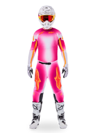 Motocross rider wearing complete racing gear, Limited Edition Supertech AFD MIG Jersey in Pink Fluo and White, matching pants with orange star accents, white helmet with red goggles, white and black boots, coordinated professional motocross outfit