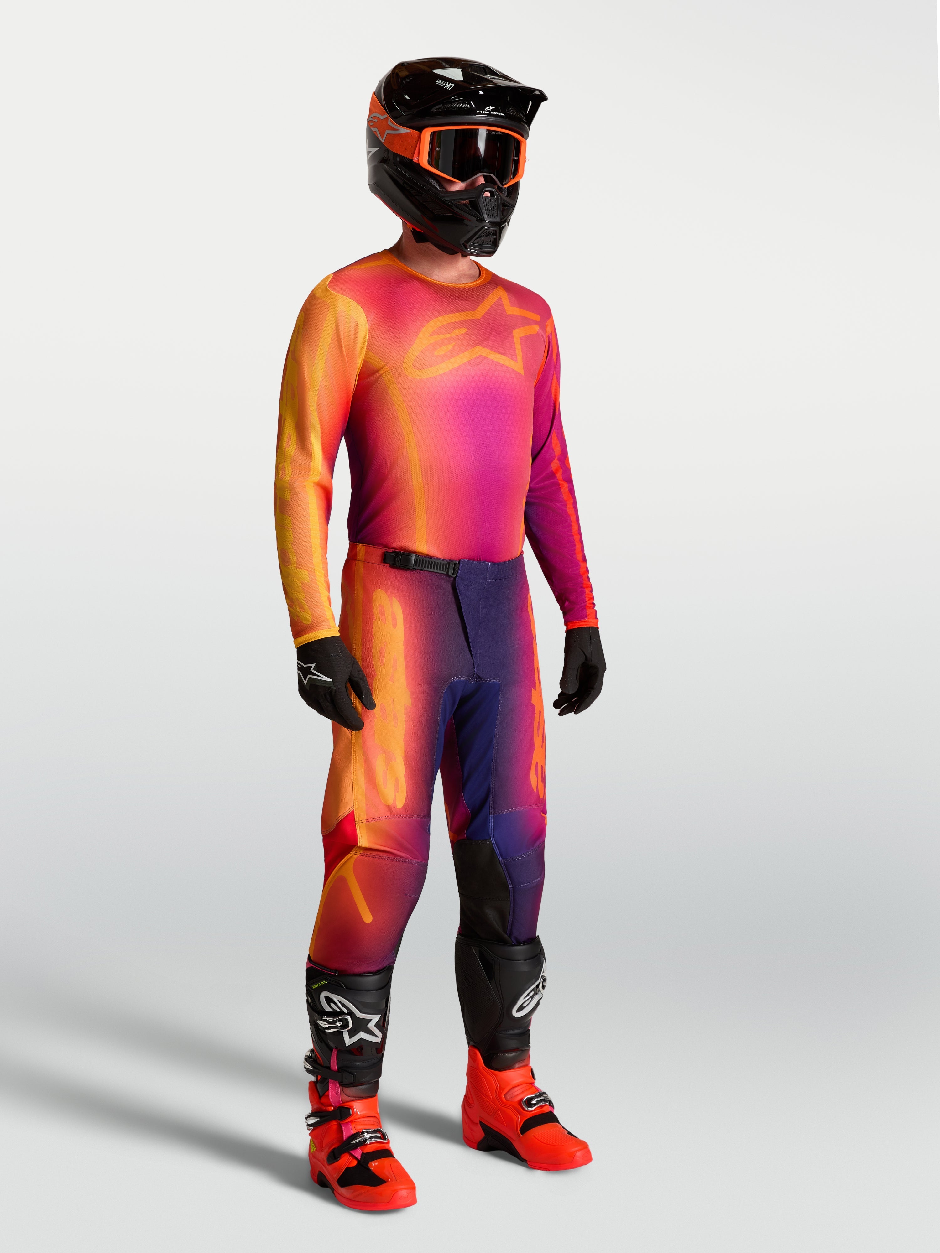 Alpinestars Fluid Kepler Jersey, purple and orange motocross jersey on-model with matching racing gear.