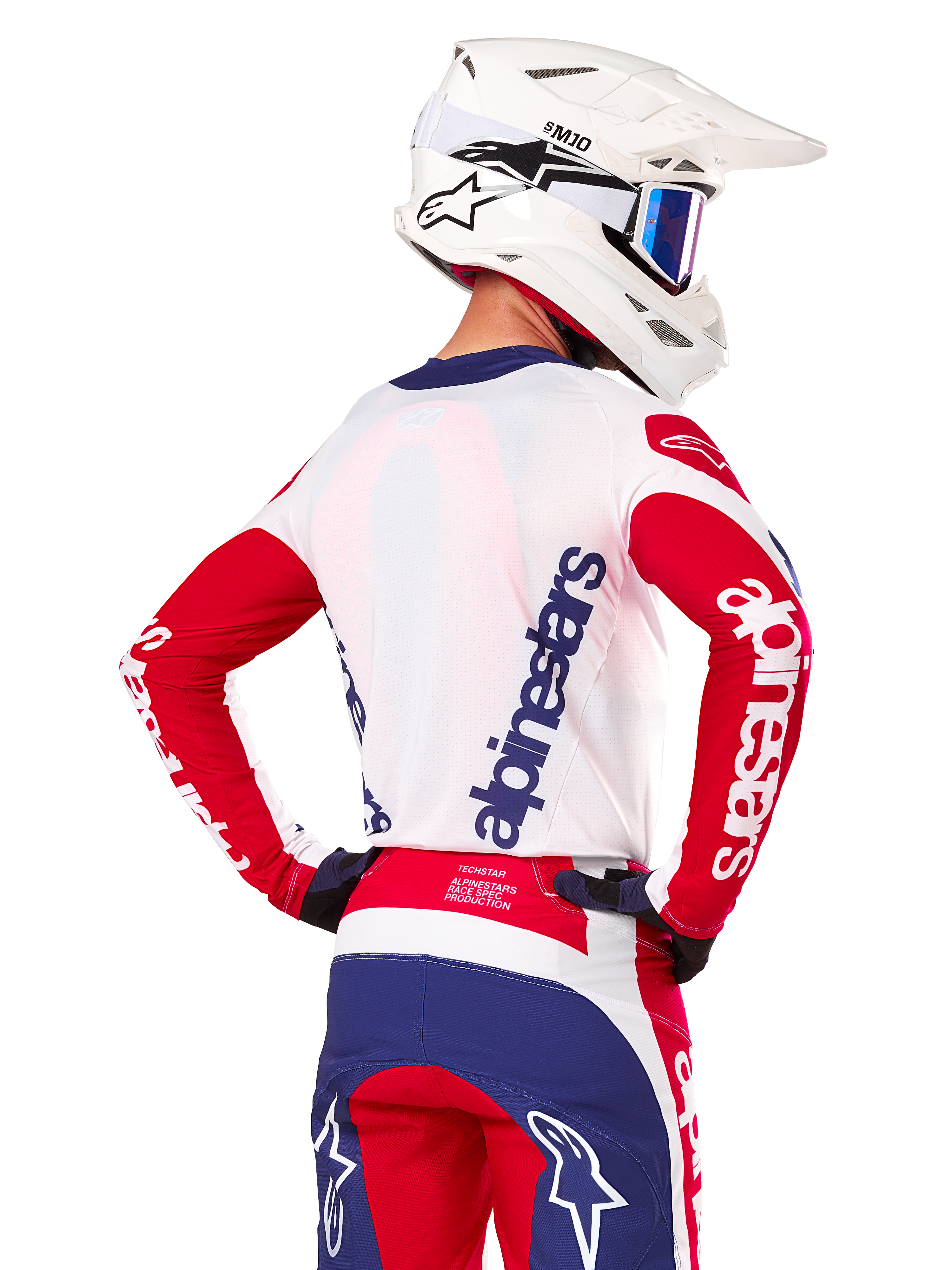 Alpinestars Limited Edition Techstar Fortitude Jersey, Motocross Jersey, Bright Red White and Blue, back view on a rider wearing a white helmet and matching gear, featuring bold Alpinestars logos on the back and sleeves, designed for high-performance off-road racing.