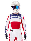Limited Edition Techstar Fortitude Jersey, Motocross Racing Jersey, White Red and Blue, worn with matching pants and helmet, featuring Alpinestars branding and One Goal One Vision motto, perforated details, sleek design for off-road performance