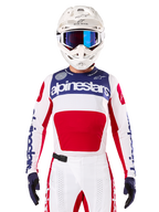 Limited Edition Techstar Fortitude Jersey, Motocross Racing Jersey, White Red and Blue, worn with matching pants and helmet, featuring Alpinestars branding and One Goal One Vision motto, perforated details, sleek design for off-road performance