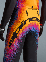Alpinestars Limited Edition Supertech Black Hole Motocross Pants, black with orange and purple cosmic splatter graphics.