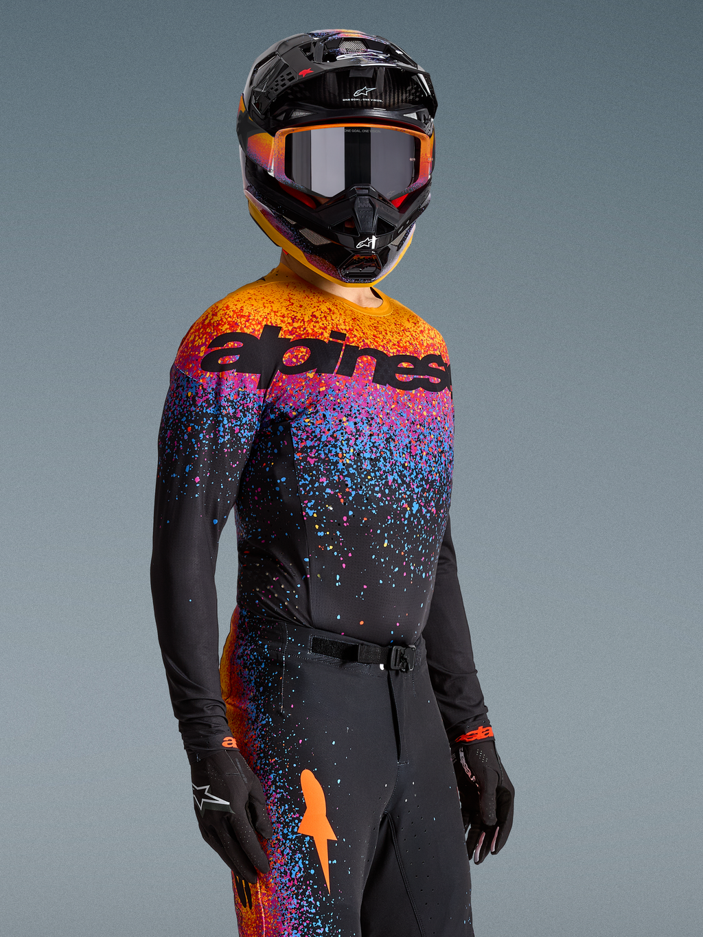 Alpinestars Limited Edition Supertech Black Hole Jersey, black motocross top with vibrant orange and purple cosmic graphics.