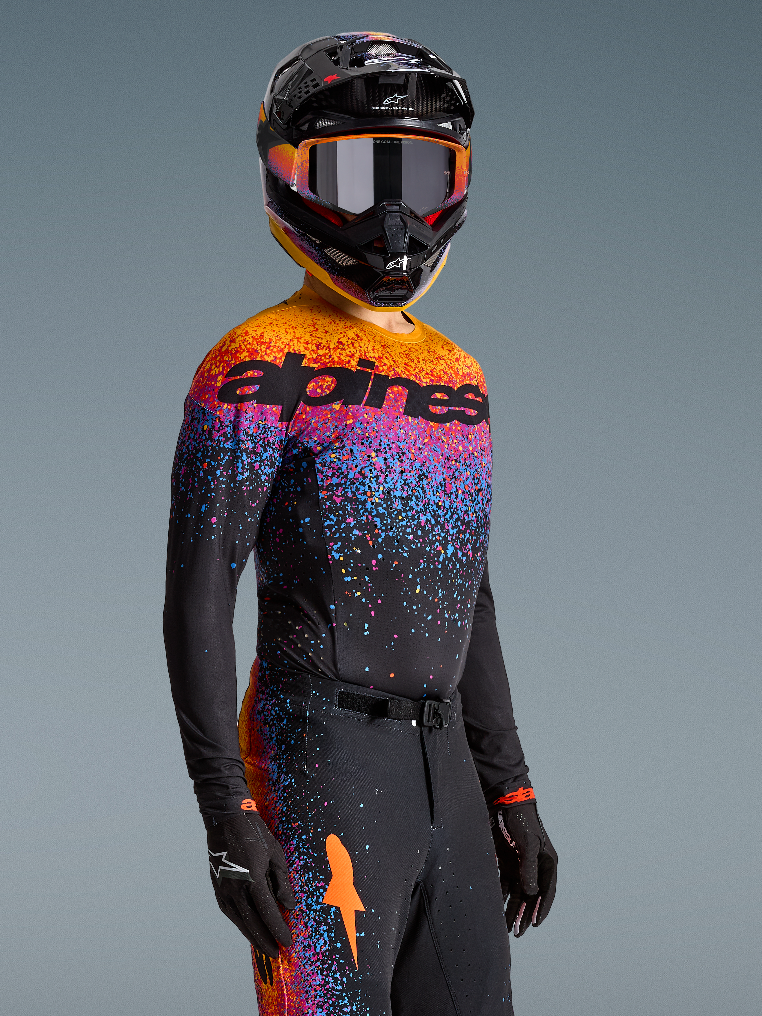 Alpinestars Limited Edition Supertech Black Hole Jersey, black motocross top with vibrant orange and purple cosmic graphics.