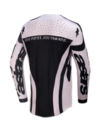 Alpinestars Techstar Wolf Dust Jersey, men's motocross top in black and white with laser-cut vents and back motto graphic.