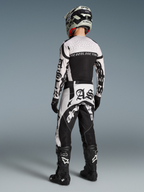 Alpinestars Limited Edition Techstar Wolf Dust Jersey and Pants, black and white motocross racing gear, back view of rider.
