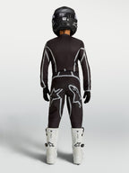 Alpinestars Youth Fluid Apex V2 Jersey and Gear Set, black and silver motocross kit with white boots, rear view.