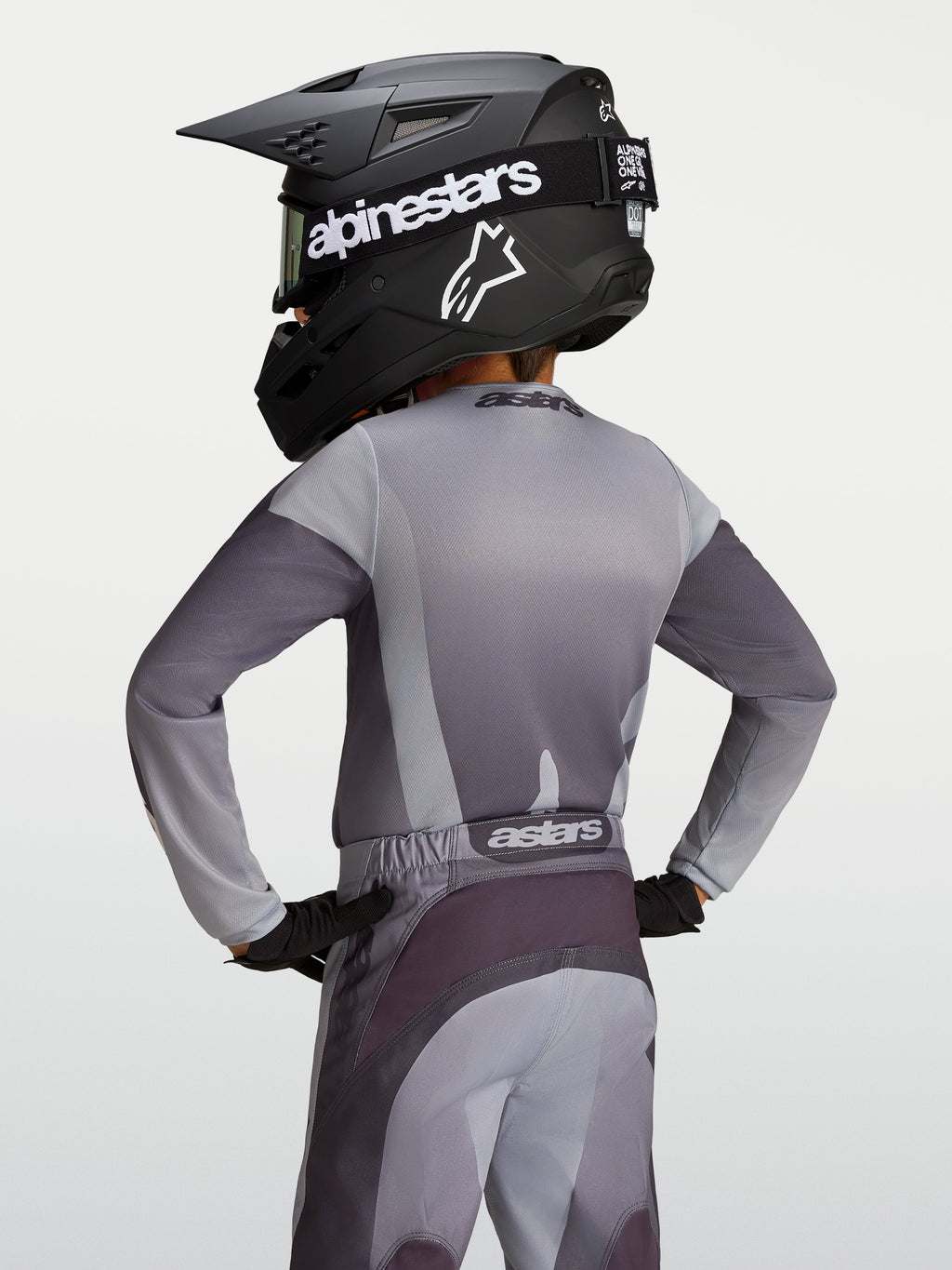 Alpinestars Youth Fluid Amber Jersey, gray and sand moisture-wicking motocross jersey on a young rider, back view.