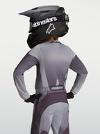 Alpinestars Youth Fluid Amber Jersey, gray and sand moisture-wicking motocross jersey on a young rider, back view.