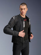 Alpinestars Viper Air V4 Jacket, Black textile motorcycle jacket, worn by male model with black jeans and base layer, unzipped front showing Tech-Air Ready and Alpinestars Protects labels, white logos on shoulders, mesh panels for airflow