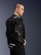 Alpinestars T-Stunt Air Jacket, Motorcycle Jacket, Black, side profile of a model wearing the sport-cut jacket with mesh sleeves and visible honeycomb-patterned armor on the shoulder and elbow, red logo on the back, white branding at the waist.