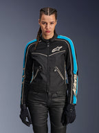 Alpinestars Stella T-Dyno Air Jacket, Women's Motorcycle Jacket, Black with Light Blue and Ecru accents, featuring mesh panels and vintage-inspired details, worn by a rider with braided hair