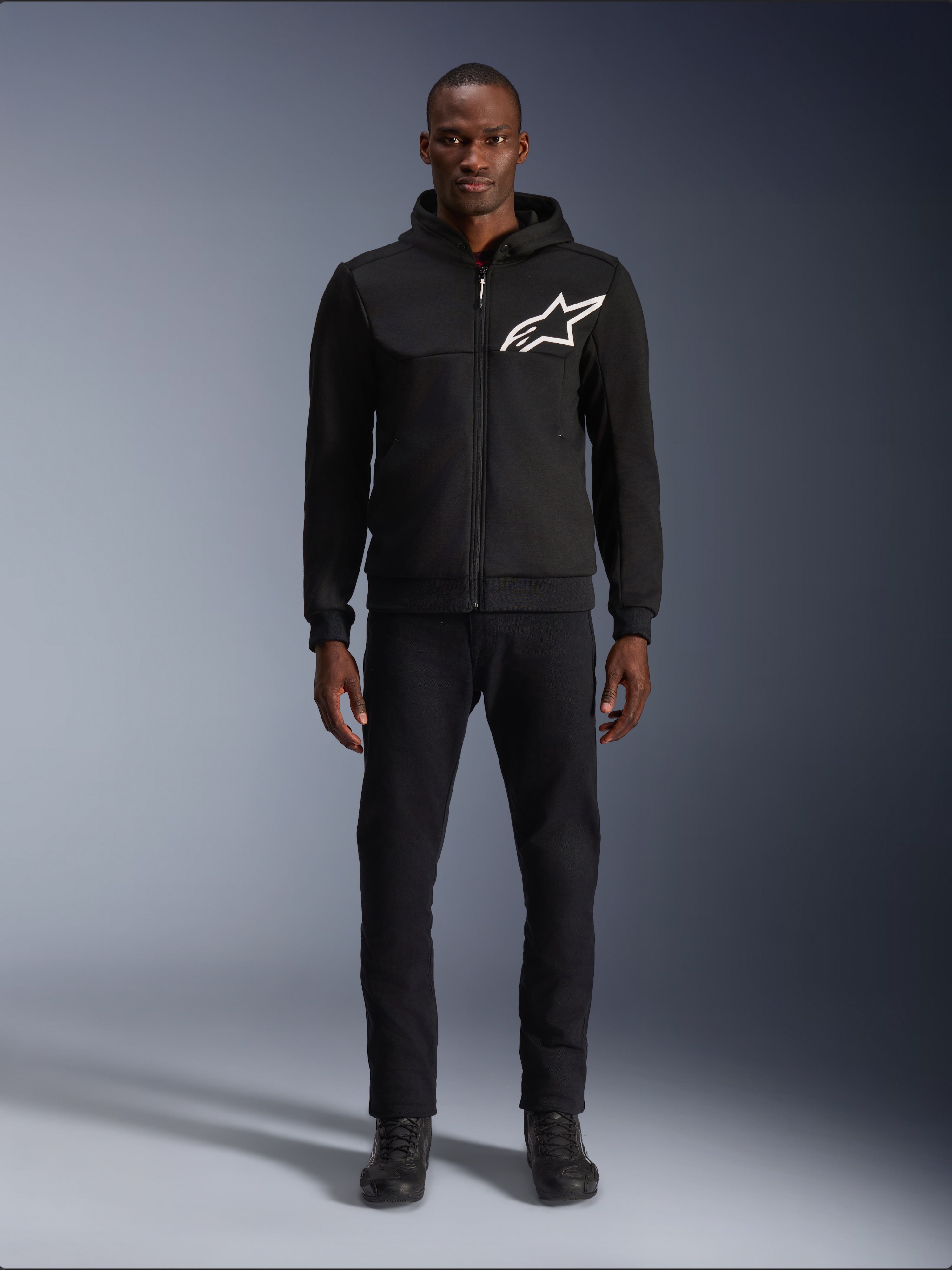 Alpinestars Chrome V2 Sport Hoodie, black men's urban riding jacket with a white logo and tech fleece, worn by a model.