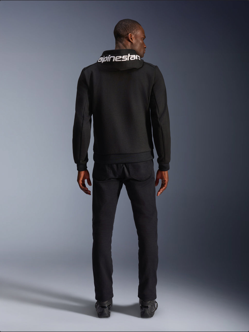 Alpinestars Chrome V2 Sport Hoodie, black tech fleece motorcycle hoodie with white hood logo, rear view on model.