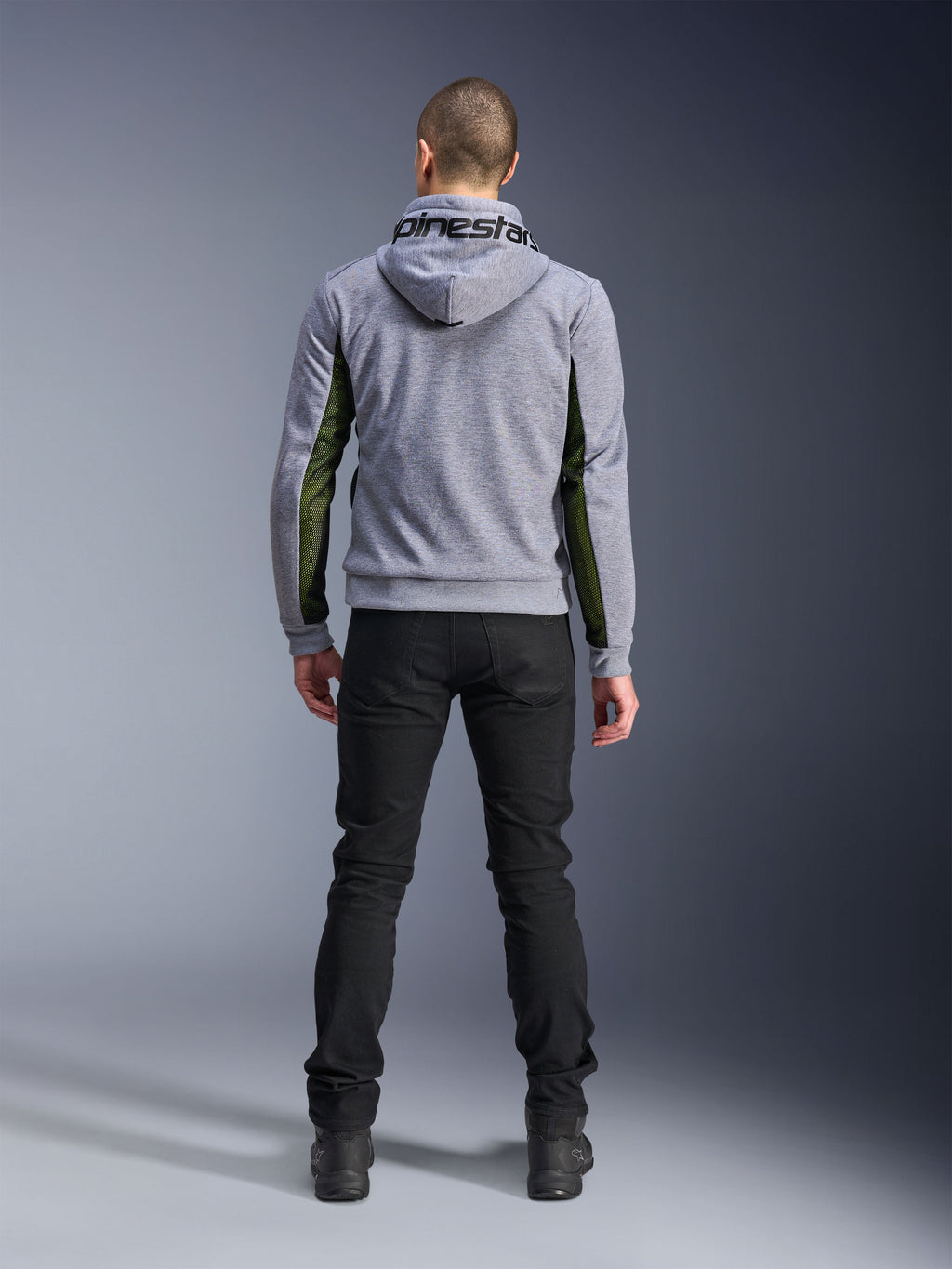 Alpinestars Chrome Air Sport Hoodie, Gray Heather Black, back view of motorcycle riding hoodie featuring green high-flow mesh panels on the sides and sleeves, tech fleece construction with Alpinestars branding on the hood, worn with black pants