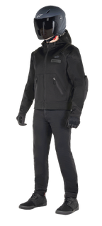 Alpinestars Moflow Air Tech Hoodie, Urban Motorcycle Hoodie, Black Black, worn by a rider with a matte black helmet, black gloves, and riding pants, featuring a full mesh construction for airflow, zippered pockets, and subtle chest logos, sleek casual design for warm weather street riding.