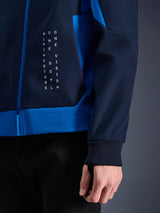 Alpinestars Radium Tech Hoodie, Urban Motorcycle Hoodie, Night Navy and Royal Blue, close-up detail showing side panel with white vertical text graphic, ribbed stretch cuff, and blue zipper closure