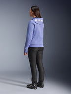 Alpinestars Woman Stella Chrome V2 Sport Hoodie, Blue Violet, rear view showing white branding on the hood, worn with black riding pants and black motorcycle boots, casual urban motorcycle gear