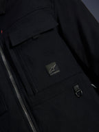 Alpinestars Bryon Water Resistant Overshirt, Black, close-up view of waxed canvas fabric, front zipper, chest cargo pocket with Alpinestars logo patch, and metal D-ring detail