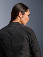 Alpinestars Woman Stella C-1 Air Jacket, Textile Motorcycle Jacket, Black, close-up rear view showing tech mesh ventilation panels and a reflective star logo on the upper back, modern urban riding gear