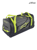 Alpinestars Komodo Travel Bag, durable motorsport gear bag and luggage, black and anthracite with yellow fluo straps and logo branding, waterproof bottom panel for racing and adventure travel