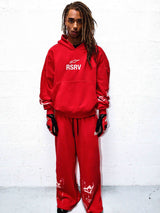 Alpinestars RSRV 2Stars Hoodie, Red, lifestyle streetwear, person wearing bright red hoodie with white RSRV logo, matching red sweatpants, premium casual motorsport-inspired apparel