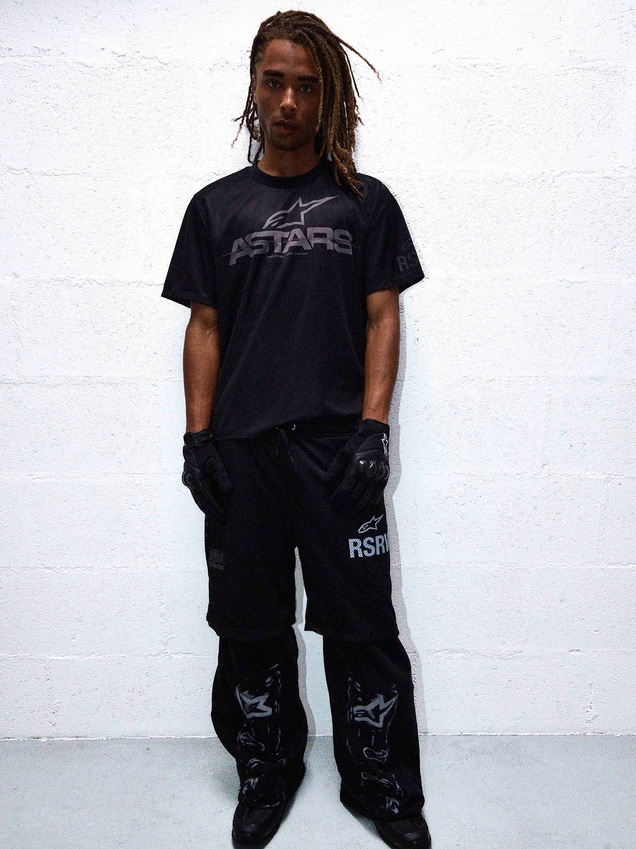 RSRV Fluid Reworked SS Jersey, black t-shirt with ASTARS graphic, worn with RSR pants, black gloves and boots, urban streetwear styling, monochromatic black outfit, motorsport-inspired fashion