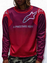 Alpinestars RSRV Racer Reworked LS Jersey, Long-Sleeve Motorsport Lifestyle Shirt, Red and Purple, White Logo Graphics, Person Wearing with Camouflage Pants, Premium Streetwear Collection