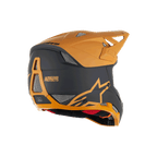 Alpinestars Missile Tech Racer Helmet, Full-Face MTB Helmet, Black and Dark Gold Matt, rear side view featuring mesh ventilation ports, aerodynamic visor, and Alpinestars Protects branding on the back, professional downhill cycling protection.