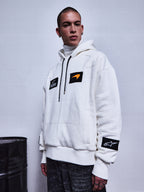 RSRV Rival Hoodie, White Lifestyle Hoodie, Unisex, with Black Patches and Orange Logo Detail, Premium Streetwear, worn with Dark Gray Pants