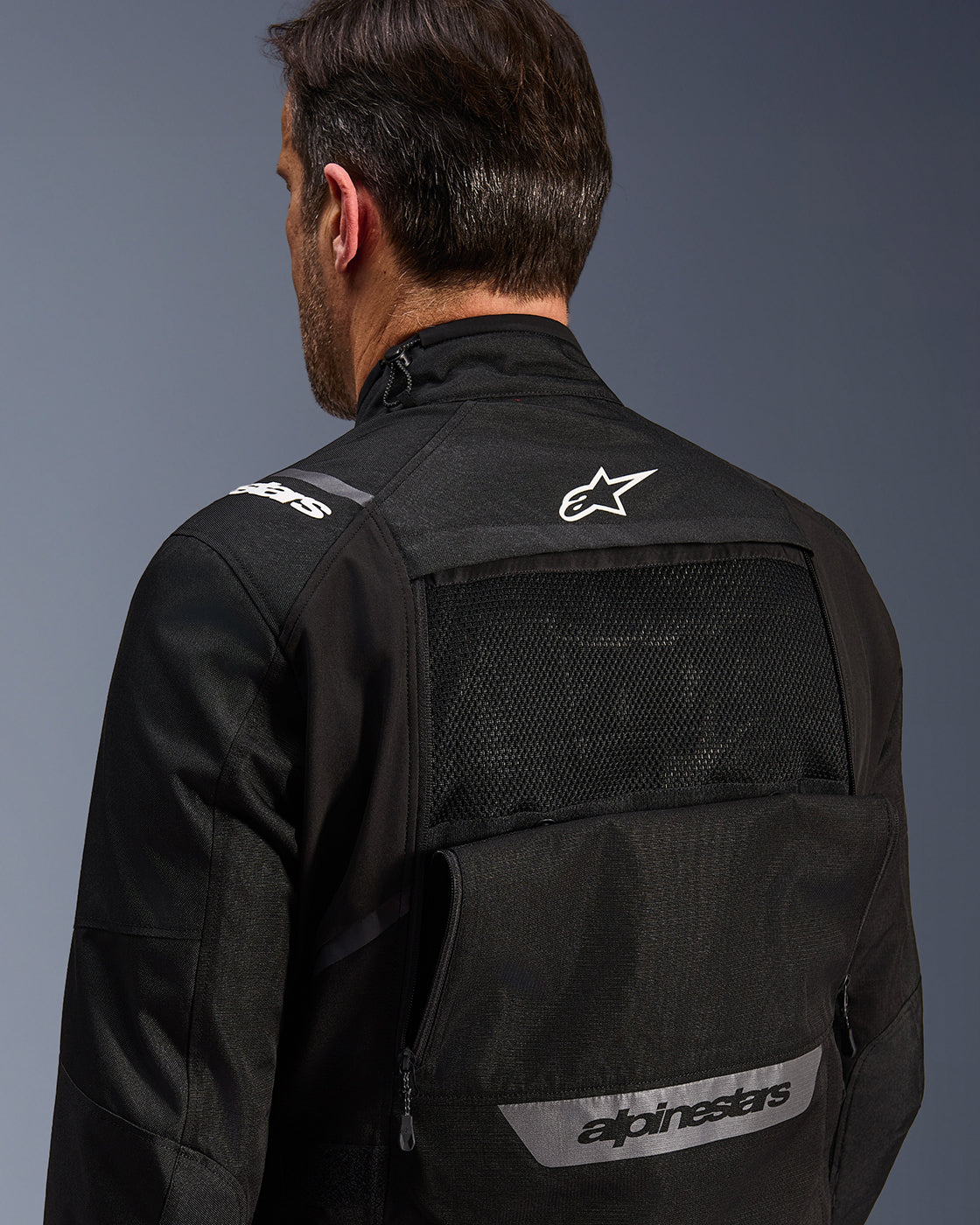 Alpinestars Cusco Drystar Jacket, black adventure touring motorcycle jacket with mesh back ventilation and white logo.