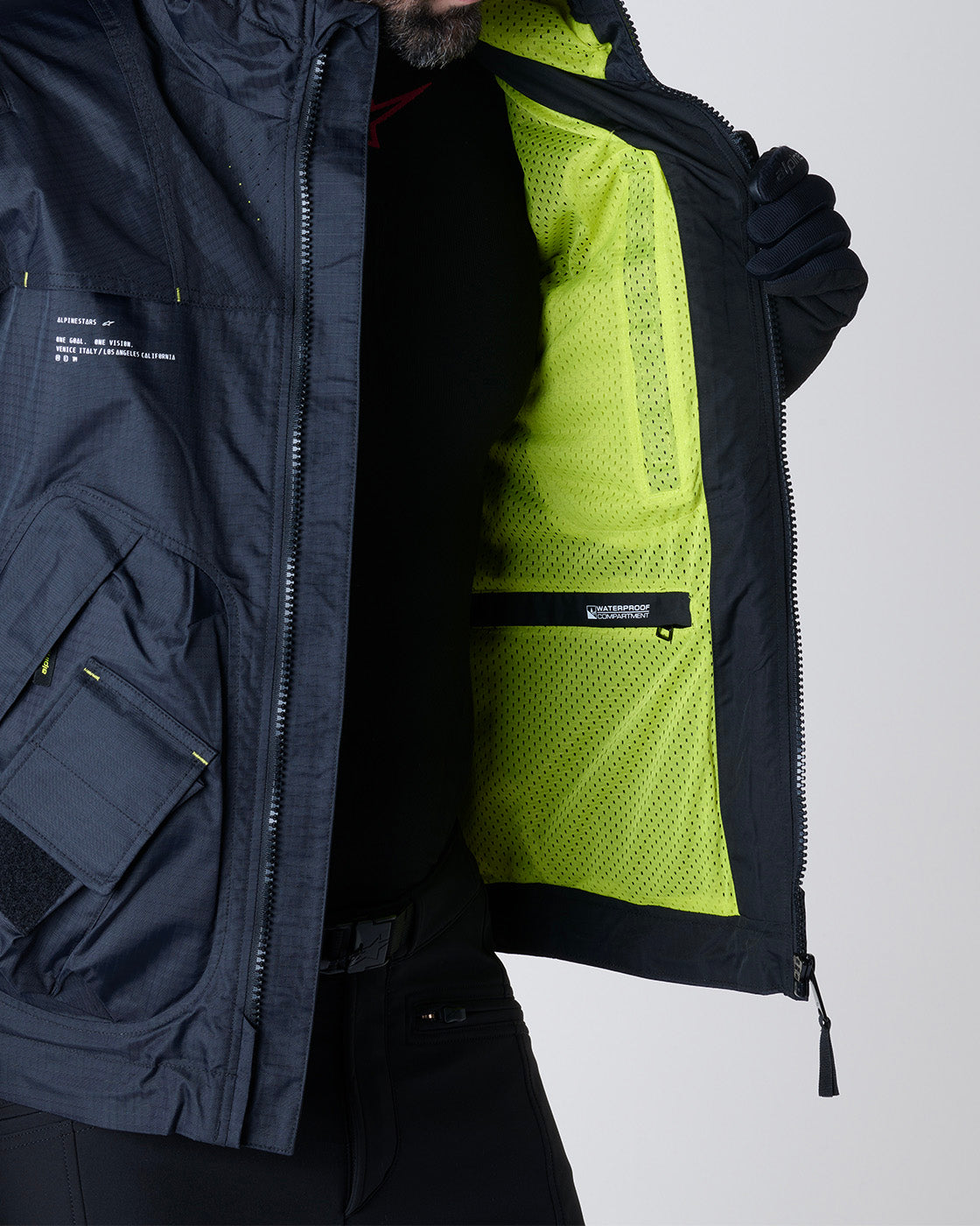 Alpinestars Mogress Air Jacket, black and almond motorcycle jacket with bright yellow inner mesh lining and visible waterproof pocket.