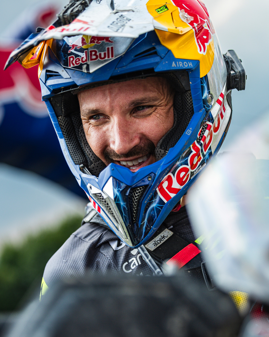 Sam Sunderland wearing a Red Bull branded helmet with a blurred background