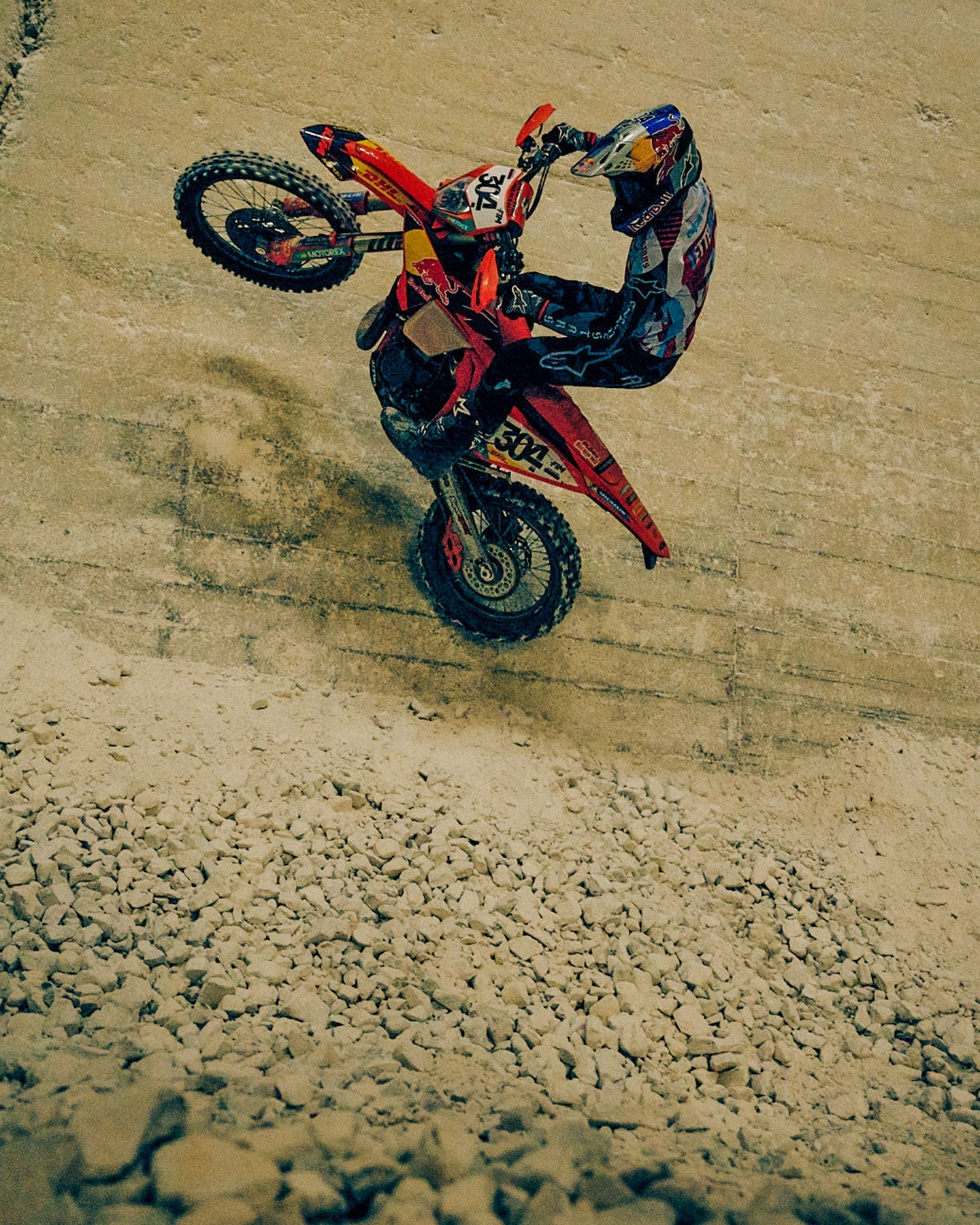 Alpinestars Limited Edition Techstar Beast Coast motocross gear, orange and black, worn by a rider jumping a dirt bike.