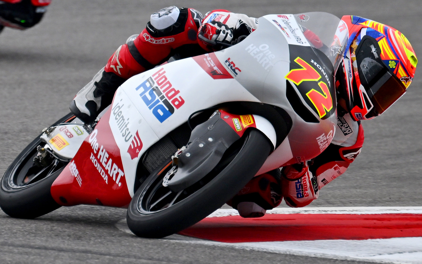 Taiyo Furusato leaning his Honda motorcycle on the track, wearing an Alpinestars moto suit