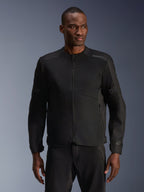 Male model wearing Alpinestars C-1 Air Jacket in Black, contemporary motorcycle jacket with extensive tech mesh panels and a full front zipper, paired with matching black riding pants, urban lifestyle and commuting aesthetic